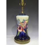 A Moorcroft Orchid pattern table lamp base, raised on a gilt metal foot, total height 43.3cm.Buyer’s
