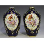 A pair of Sèvres style pottery vases, 20th century, decorated with panels of floral sprays against a