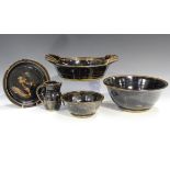 A collection of studio pottery, including various bowls, plates and jugs by Paul Green, covered in a