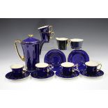 A Crown Devon Fieldings Modane Art Deco blue glazed coffee set with mother-of-pearl interiors and