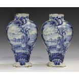A pair of Dutch Delft vases, 18th century, of baluster shape, both painted in blue with a winter