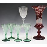 A Bohemian ruby flashed and cut glass vase, late 19th century, the flared trumpet body engraved with
