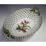 A Meissen pierced oval basket, 19th century, painted to the base interior with a floral bouquet, the
