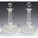 A pair of cut glass decanters and stoppers, 20th century, each bulbous body engraved with a band