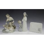 Two Lladro porcelain figures, comprising Caressing a Little Calf, No. 4827, and Teaching to Pray,
