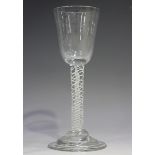 A double-series opaque twist stem wine glass, circa 1770, the round funnel bowl raised on a plain