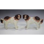 A pair of Staffordshire pottery models of St Bernard dogs, late 19th century, modelled standing with