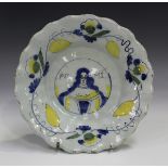 An unusual Delft portrait dish, late 17th/early 18th century, of circular shape, moulded with two