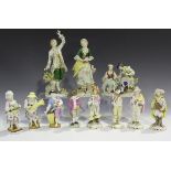 A group of Continental porcelain figures, late 19th/20th century, comprising a pair of figures by