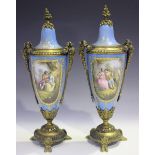 A pair of gilt metal mounted Sèvres style vases and covers, late 19th/early 20th century, each