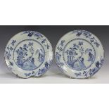 A pair of dated English Delft plates, 1776, painted in blue with a peacock perched on a