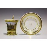 A Paris porcelain cup and saucer, early 19th century, the flared gilt ground cup painted with a