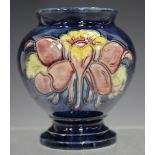 A Moorcroft pottery Columbine pattern vase, second half of 20th century, the blue glazed baluster