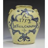 A tin-glazed earthenware pottery jar, possibly Spanish, dated 1752, the ribbed tapered body