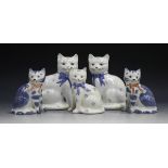 Five David Sharp Rye pottery cats, three decorated with flowerheads and blue bow ties, printed