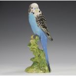 A Beswick blue budgerigar, No. 1216B, height 17.8cm.Buyer’s Premium 29.4% (including VAT @ 20%) of