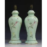 A pair of Royal Worcester table lamp bases, circa 1952, of lobed tapering form, decorated with