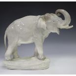 An Amphora Czechoslovakia pottery model of an elephant, early 20th century, with raised trunk, on