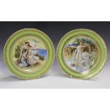 A pair of Vienna style porcelain plates, late 19th century, both decorated with Classical maidens by