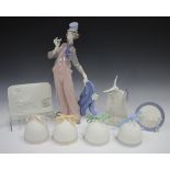 A Lladro porcelain figure A Mile of Style, No. 6507, and four Lladro bells, all boxed, together with