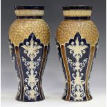 A pair of Royal Doulton stoneware vases, first half 20th century, decorated with scrolling floral