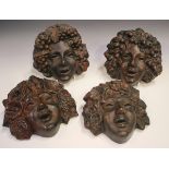 A set of four Art Deco style terracotta wall masks representing the Seasons, 20th century,