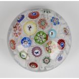 A Baccarat glass spaced millefiori paperweight, dated 1848, set with a variety of canes, including