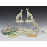 A pair of Parian models of greyhounds, second half 19th century, the seated animals raised on