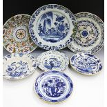 Seven assorted Dutch Delft chargers and plates, mid to late 18th century, comprising two