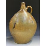 A large German stoneware salt glazed Bellarmine style jug, late 18th/19th century, of elongated