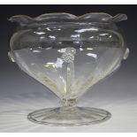 A Powell type clear glass footed bowl, early 20th century, the baluster body with flared notched
