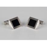 A pair of white gold, diamond and black onyx dress cufflinks, each with a rectangular black onyx