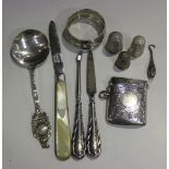 A group of silver items, comprising an Edwardian rectangular vesta case with engraved decoration,