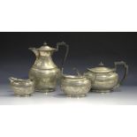 A George V silver four-piece tea set, each oval body engraved with foliate garlands, comprising