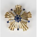 A gold, sapphire and diamond brooch in a cinquefoil shaped design, the centre with a sapphire