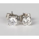 A pair of 18ct white gold and diamond single stone earstuds, each claw set with a circular cut