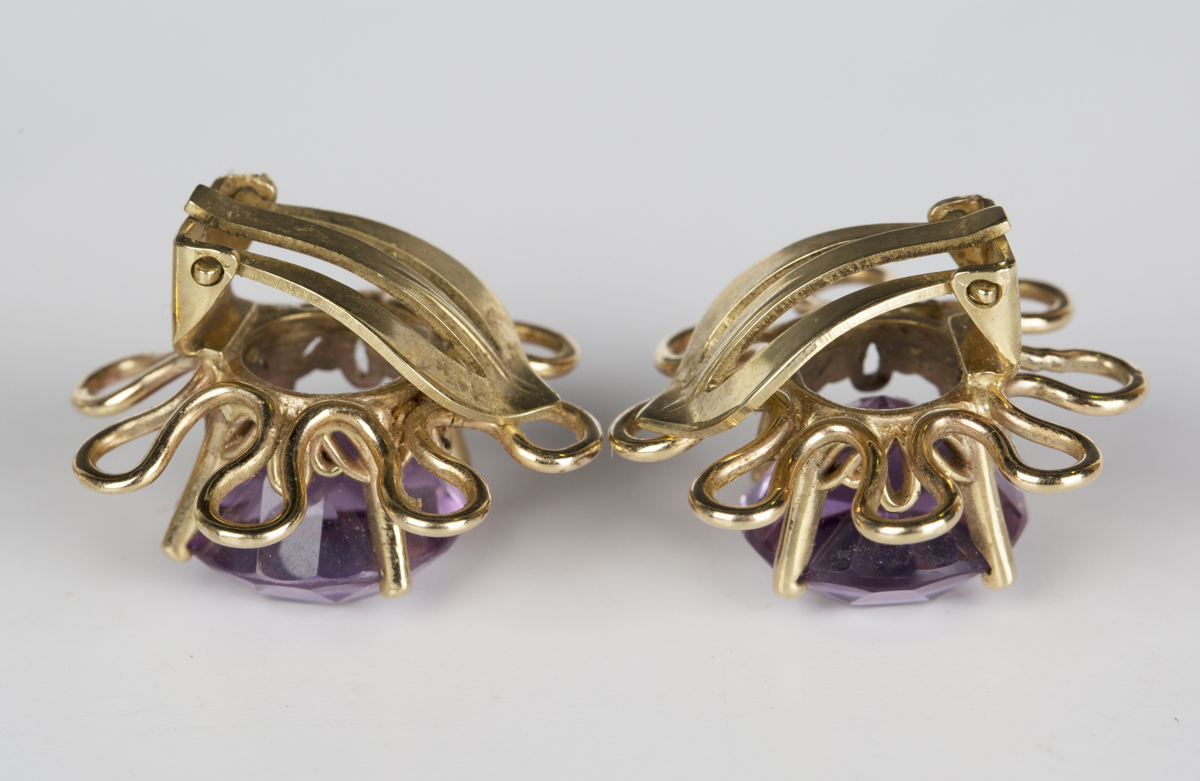 A pair of amethyst single stone earclips, each claw set with a circular cut amethyst within a looped - Image 3 of 3