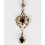 A 9ct gold and garnet two stone pendant, mounted with a pear shaped garnet to the drop and with an