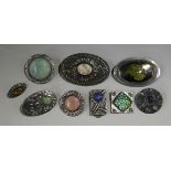 A group of six pewter fronted brooches, mounted with vari-coloured glazed ceramic panels, possibly