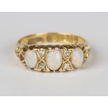 A late Victorian 18ct gold, opal and diamond ring, mounted with three oval opals alternating with