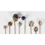 A rose cut diamond and lapis lazuli stickpin, designed as an arrow piercing a bead, width 2.2cm, a