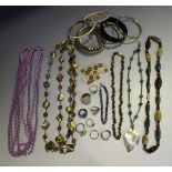 A large collection of costume jewellery, including eleven loose semi-translucent amber beads, a