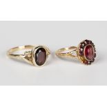 A gold and garnet set oval cluster ring, detailed '9ct', ring size approx M (one garnet lacking),