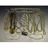 A large collection of costume jewellery, including a group of shell necklaces and various rings,
