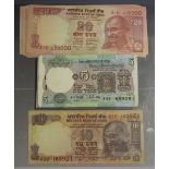 A collection of Indian banknotes, including a consecutive run of one hundred five rupees, stapled,