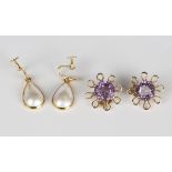 A pair of amethyst single stone earclips, each claw set with a circular cut amethyst within a looped