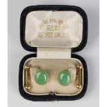 A pair of Chinese gold and jade set cufflinks, each mounted with an oval jade cabochon front and