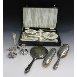 A plated and enamelled four-piece dressing table set, comprising hand mirror, comb, hairbrush and