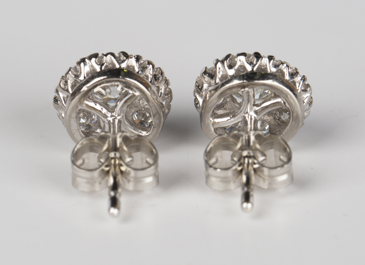 A pair of diamond cluster earrings, each claw set with the principal circular cut diamond within a - Image 3 of 4