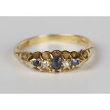 An Edwardian 18ct gold, sapphire and diamond five stone ring, mounted with three cushion cut